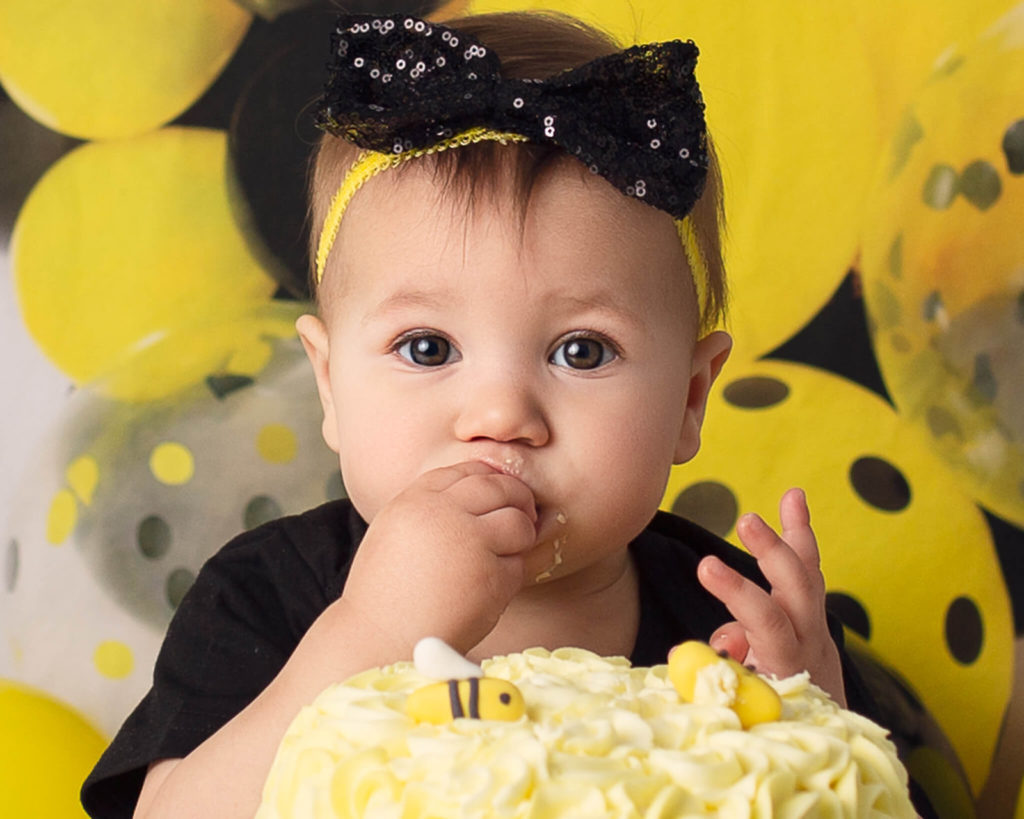 Bee-themed cake smash photoshoot by newborn photographer in Akron, OH