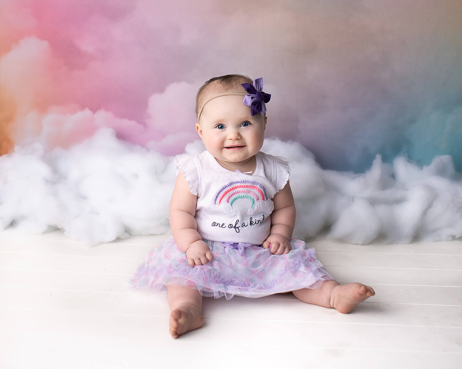 Canton OH newborn photographer captures happy baby girl during their milestone photo session