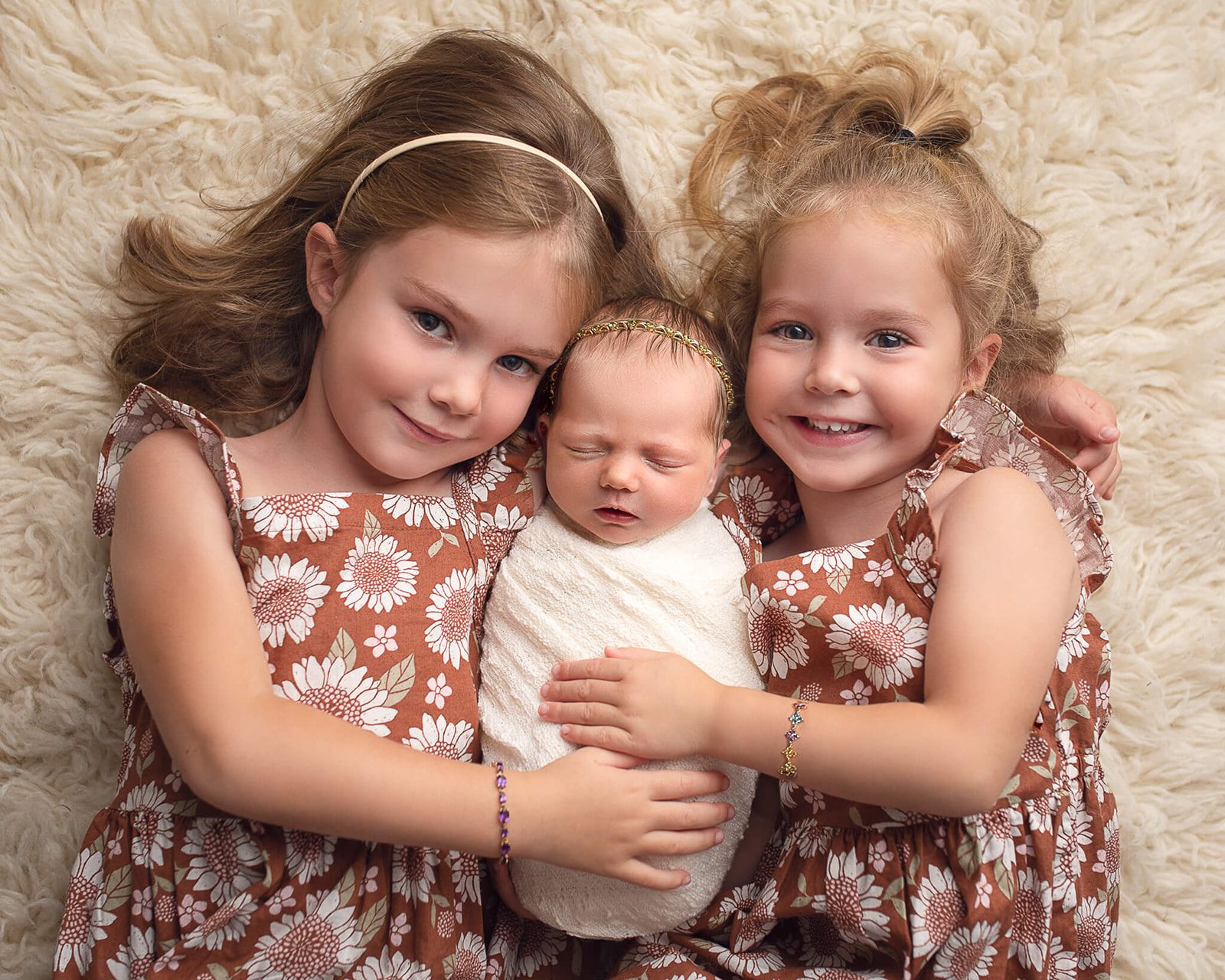 how to prepare your toddler for a newborn lessons with two girl siblings and a newborn smiling