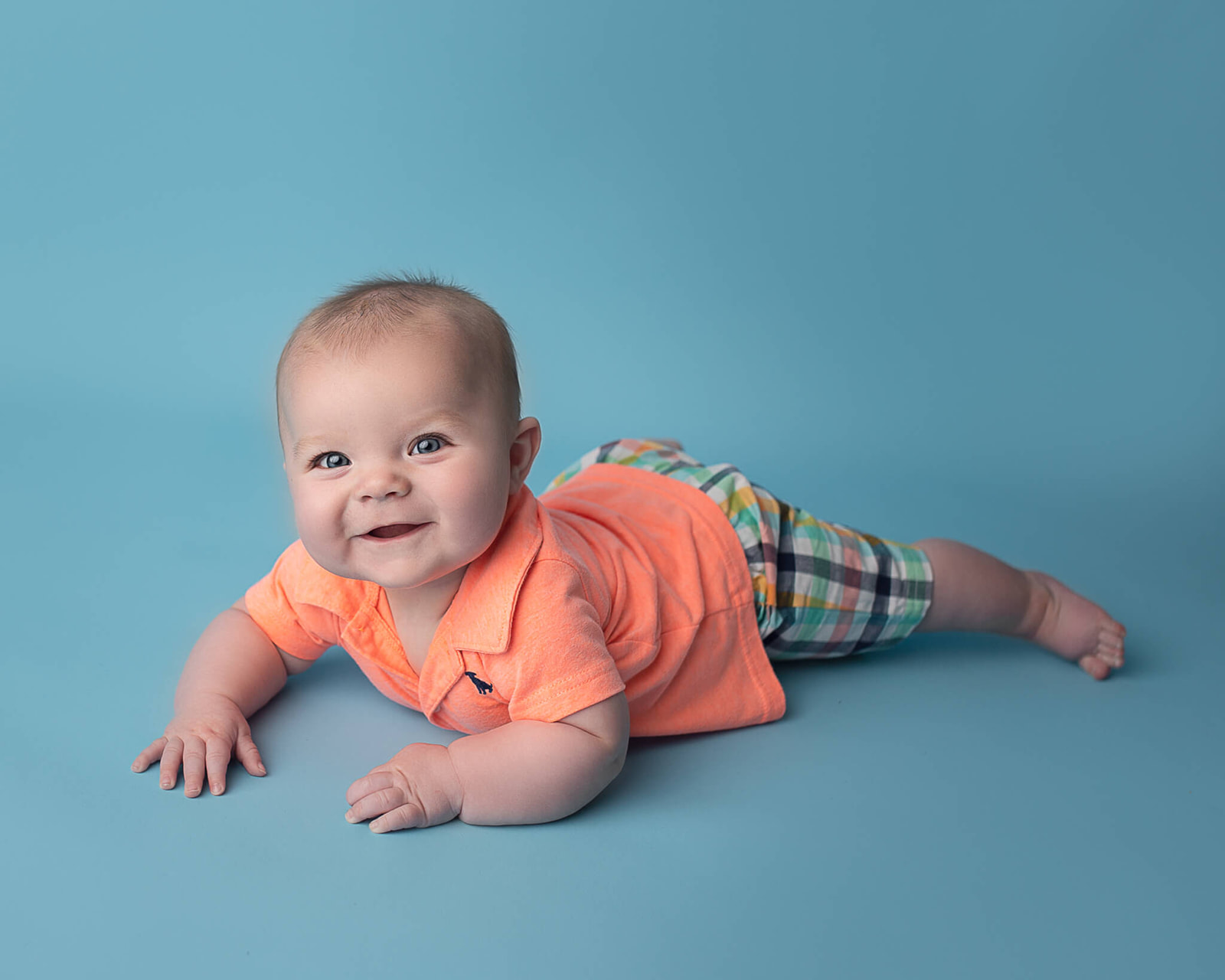 newborn smiling on belly during newborn photo session