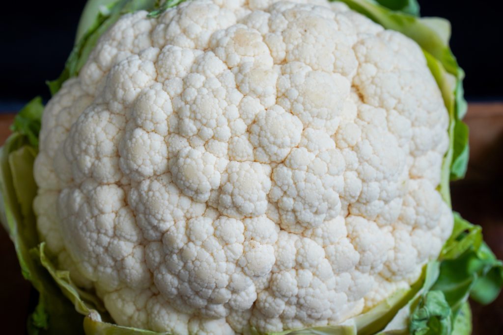 head of cauliflower representing the size of the baby in your belly