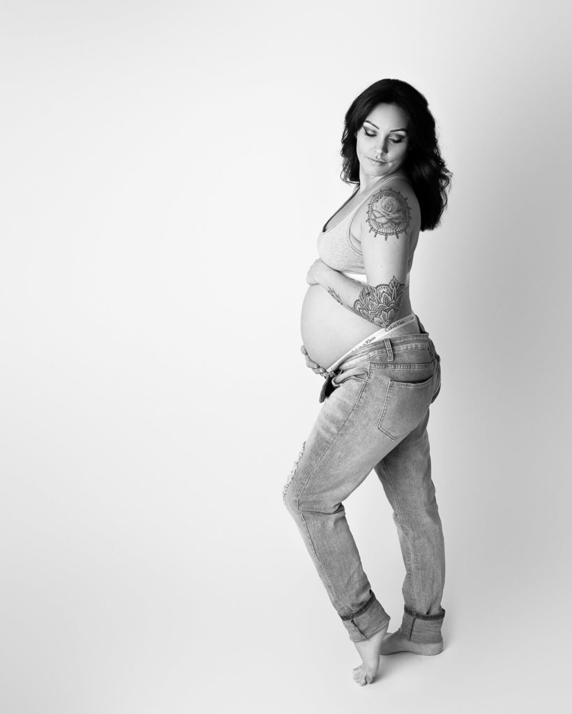 morning sickness tips for akron moms in blog photo of pregnant mom holding her belly in black and white