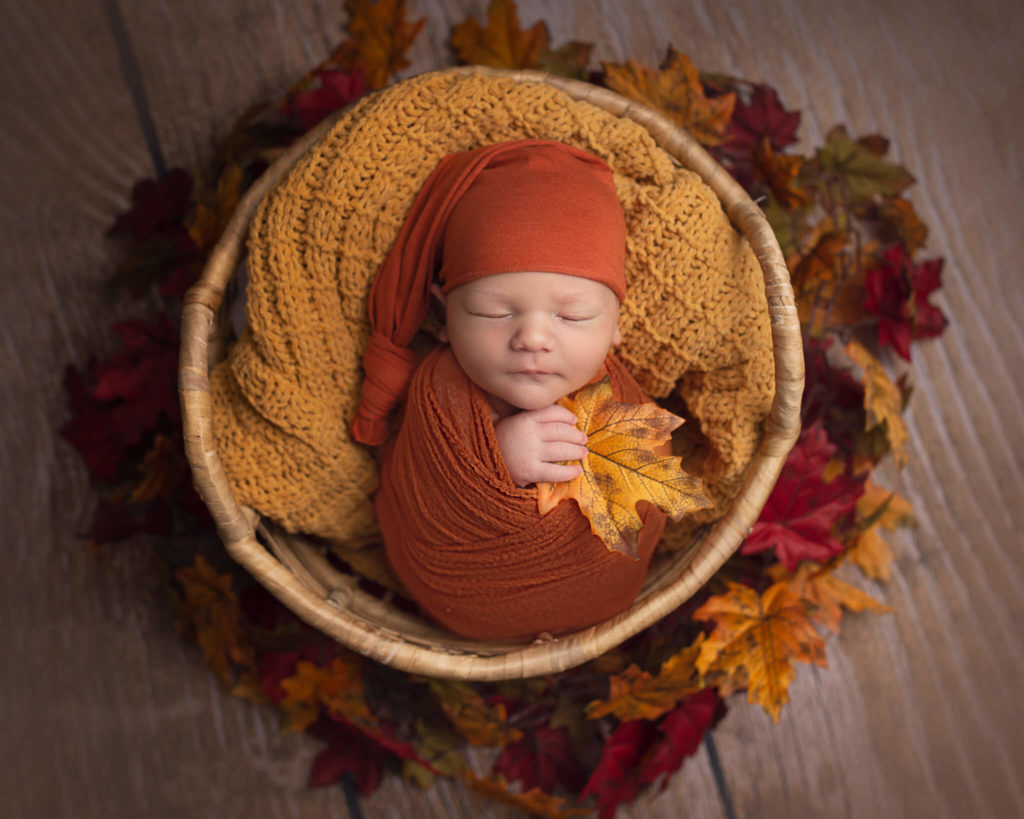 pediatric physical therapists in akron in blog photo of sleeping newborn in fall themed basket