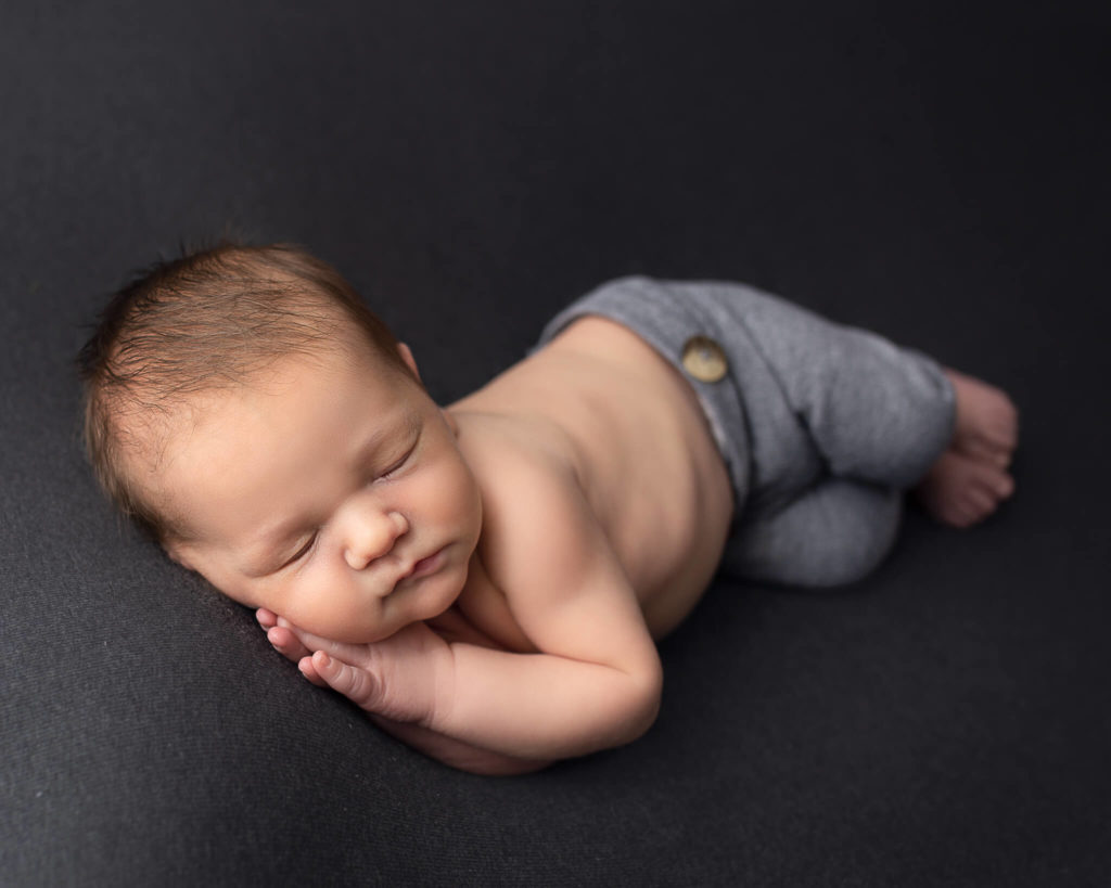 guide to newborn care for Akron parents in blog photo of sleeping newborn 
