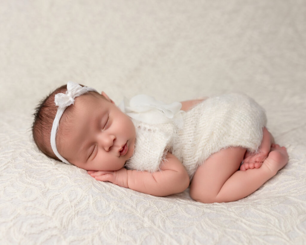 Newborn photography safety natural baby pose on posing bed Canton Ohio